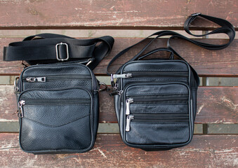 2 men's leather purse bags with zippers, close-up. Two purses, purse with straps.