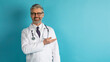 © Prostock-studio - Friendly grey-haired doctor showing copy space for ad on blue