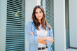© Jose Calsina - Caucasian serious young female student with arms crossed looking pensive at camera in casual clothes outdoors. Close up portrait of a pensive teenage woman with confident face expression posing. High