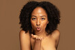 © Prostock-studio - Sensual topless young black woman sending fly kiss
