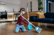 © DimaBerlin - Little boy sweeping floor in living room, kid doing daily regular household chores and helping parents around house, gain important life skills. Children and housework concept