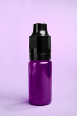 Wall Mural - Bottle with purple food coloring on bright background