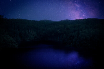 Wall Mural - Amazing starry sky reflecting in lake. Beautiful night landscape