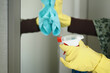 © Towfiqu Barbhuiya  - close up of person hand in gloves cleaning window glass