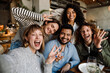 © Drobot Dean - Group of cheerful friends taking selfie while dining in restaurant