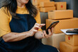 © laddawan - .Mature business owner woman prepare parcel box and standing check online orders for deliver to customer on tablet, laptop Shopping Online