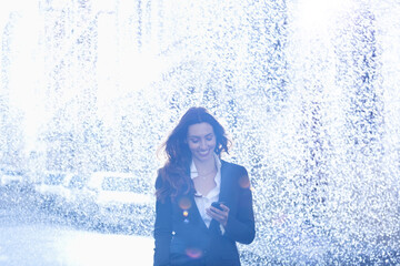 Wall Mural - Happy businesswoman text messaging with cell phone in rain