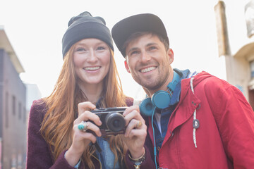 Canvas Print - Couple taking photographs with camera in city