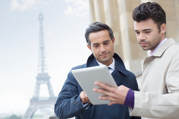 Poster - Businessmen using digital tablet near Eiffel Tower, Paris, France