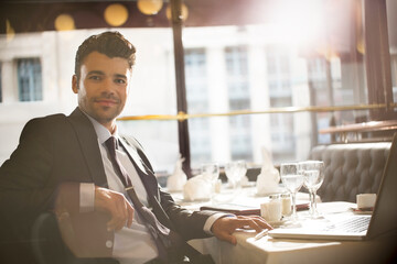 Wall Mural - Businessman smiling in restaurant