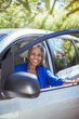 © KOTO - Portrait of confident senior woman getting out of car