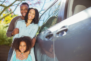 Canvas Print - Portrait of happy family outside car