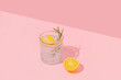 © Adela - Summer creative layout with coctail glass and lemon half on pink background. 80s or 90s retro aesthetic idea. Minimal summer coctail idea.