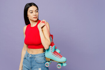 Wall Mural - Side profile view calm serious young latin woman wear red casual clothes hold rollers look aside on area isolated on plain pastel purple background studio portrait. Summer lifestyle leisure concept.