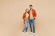 © ViDi Studio - Full body smiling happy cheerful fun cool young couple two friends family man woman wear casual clothes together looking camera hugging isolated on pastel plain beige color background studio portrait.
