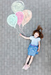 © Photocreo Bednarek - Young girl with balloons painted on pavement