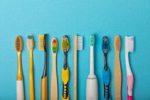 Electric And Manual Toothbrushes On A Blue Background. View From Above. Oral Hygiene. Ordinary Toothbrush, Eco And Electric Toothbrush. Oral Hygiene. Oral Care Kit. Dentist Concept. Dental Care. 