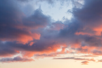 Beautiful sunset sky. Clouds illuminated by red sunlight at sunset. This view of the sky with clouds at sunset is great for background and design.