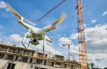 Wall Mural - drone flying over construction site. video surveillance or industrial safety inspection