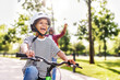Leinwandbild Motiv Happy family father teaches child  son  to ride bike in park  .