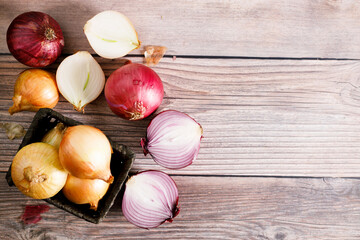 Wall Mural - colorful onions on rustic wooden background.