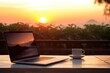 © Thares2020 - Laptop, Coffee, and the Sunset. Perfect Online Workstation on a Wooden Table. Work online concept.