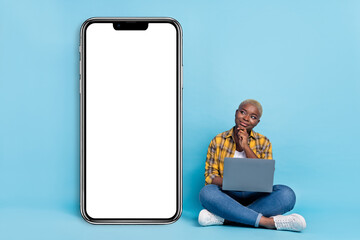 Full length photo of beautiful thoughtful lady wear checkered shirt chatitng modern device empty space isolated blue color background