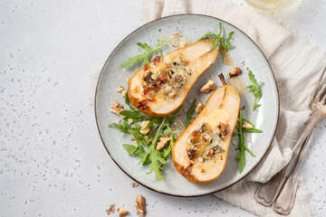 Wall Mural - Pear baked with blue cheese, honey and walnuts with arugula salad