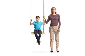 Poster - Mother standing next to a son on a swing