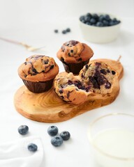 Sticker - Vertical shot of homemade delicious blueberry muffins with one broken open