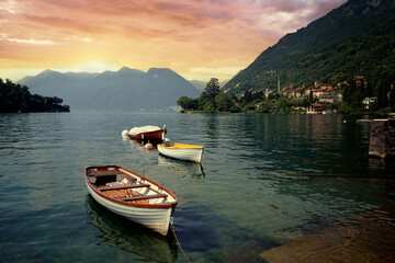 Wall Mural - Beautiful scene of boats on lake Como in Italy. A big blue lake surrounded by green hill.