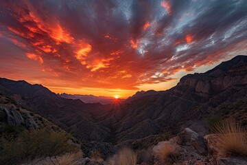 Wall Mural - fiery sunset over canyon, with clouds and mountains in the background, created with generative ai