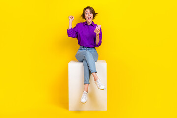 Poster - Full length photo of pretty lucky woman dressed purple shirt winning game modern device isolated yellow color background
