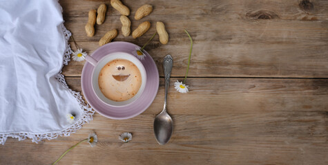 cup with drink coffee cappuccino and foam in smile form on old vintage wooden table, caffeine improves functioning of human brain, stimulates nervous system, health benefits and harms, copy space