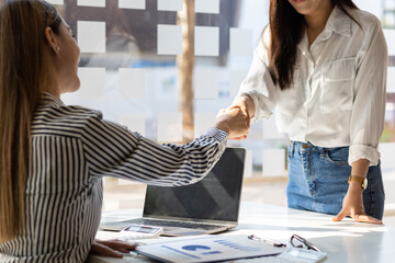 Businesswoman colleague partner is discussing and planning a collaboration, handshake.