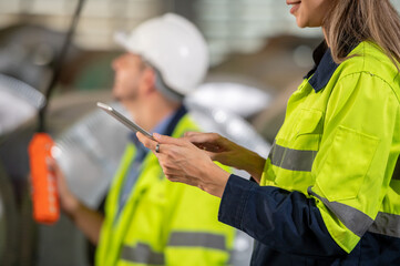 Wall Mural - Factory apprenticeship. Woman mentor teaching man employee trainee operating machine look monitors and hand press control button process machinery. Leader foreman explaining engineer control machine