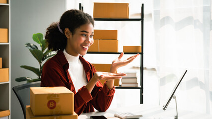 African american woman use tablet to video call and talking with client while working in warehouse