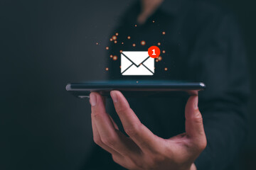 New email notification concept for business e-mail communication and digital marketing. Businessman holding mobile and inbox receiving electronic message alert. Internet technology.