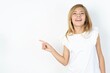 © Jihan - beautiful caucasian teen girl wearing white T-shirt over white wall laughs happily points away on blank space demonstrates shopping discount offer, excited by good news or unexpected sale.
