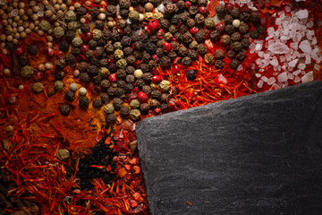 Canvas Print - Variety of spices and black slate stone as background. Food spice and ingredients