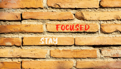 Stay focused symbol. Concept words Stay focused on beautiful brown bricks on a beautiful brick wall background. Business, support, motivation, psychological and stay focused concept. Copy space.