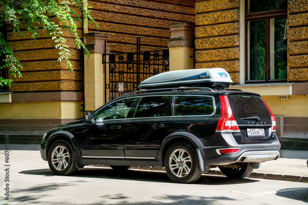 Black Volvo XC70 v70 XC second generation with Thule roof rack box is parked in Subotica Serbia 27.05.2023. Back side view. Stock Photo Adobe Stock