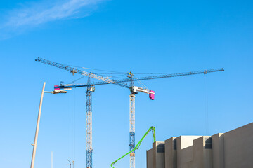 Wall Mural - Construction cranes against blue sky