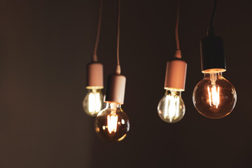 Glowing light bulbs in dark room