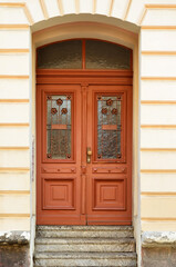 Wall Mural - View of old building with wooden door and steps