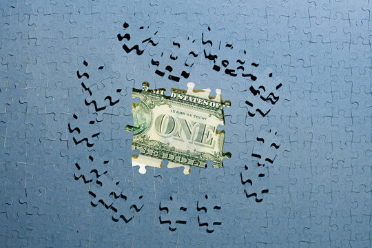 Wall Mural - dollar inflation, hiding income concept, dollar bill hidden under unfinished puzzles