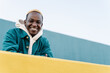 Smiling young African American man with dyed hair and hoodie. Generation Z youth