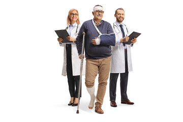 Wall Mural - Mature male patient with leg and head injury standing in front of two doctors