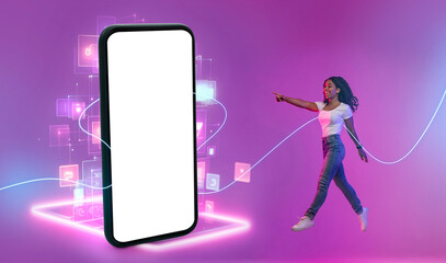 Poster - Magic world of internet. Full length portrait of young black woman going of huge cellphone glowing in neon light