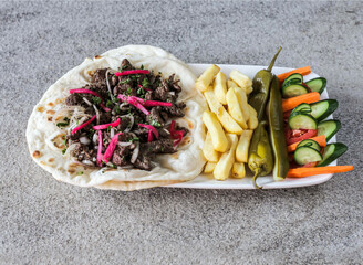 Wall Mural - Beef shawarma platter with french fries and salad served in dish isolated on background top view of fast food